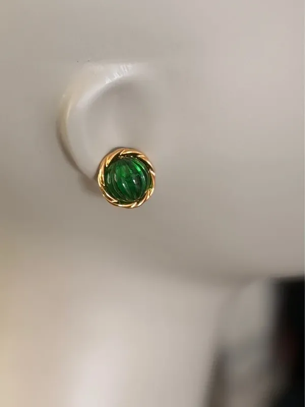 Vintage Green Avon earrings feature a prominent green, ribbed glass cabochon stone