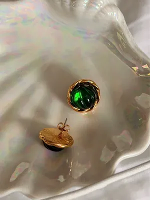 Vintage Green Avon earrings feature a prominent green, ribbed glass cabochon stone